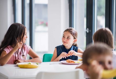 a-group-of-cheerful-small-school-kids-in-canteen-e-ZPRW6P6-min-scaled
